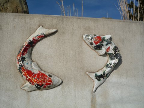 Decorative fish adorn wall on Coney Island boardwalk